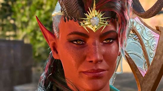 Baldur's Gate 3 Karlach has red skin, pointed ears, and a gold jewel adorned at the top of her forehead