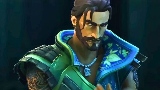 Valorant agent tier list: a closeup of Harbor, a bearded man wearing a necklace, a strand of hair falls over his face.