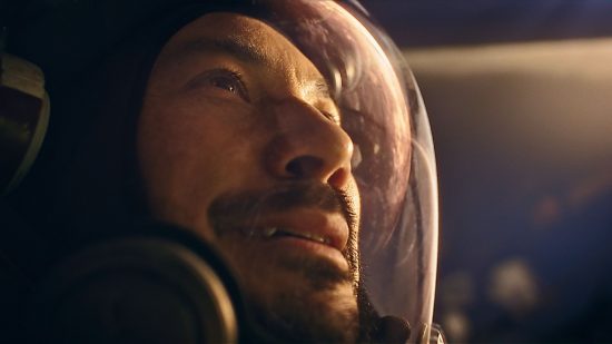 The best space games: Barrett looks out into the atmosphere with a reflection shining off his space suit helmet in Starfield.